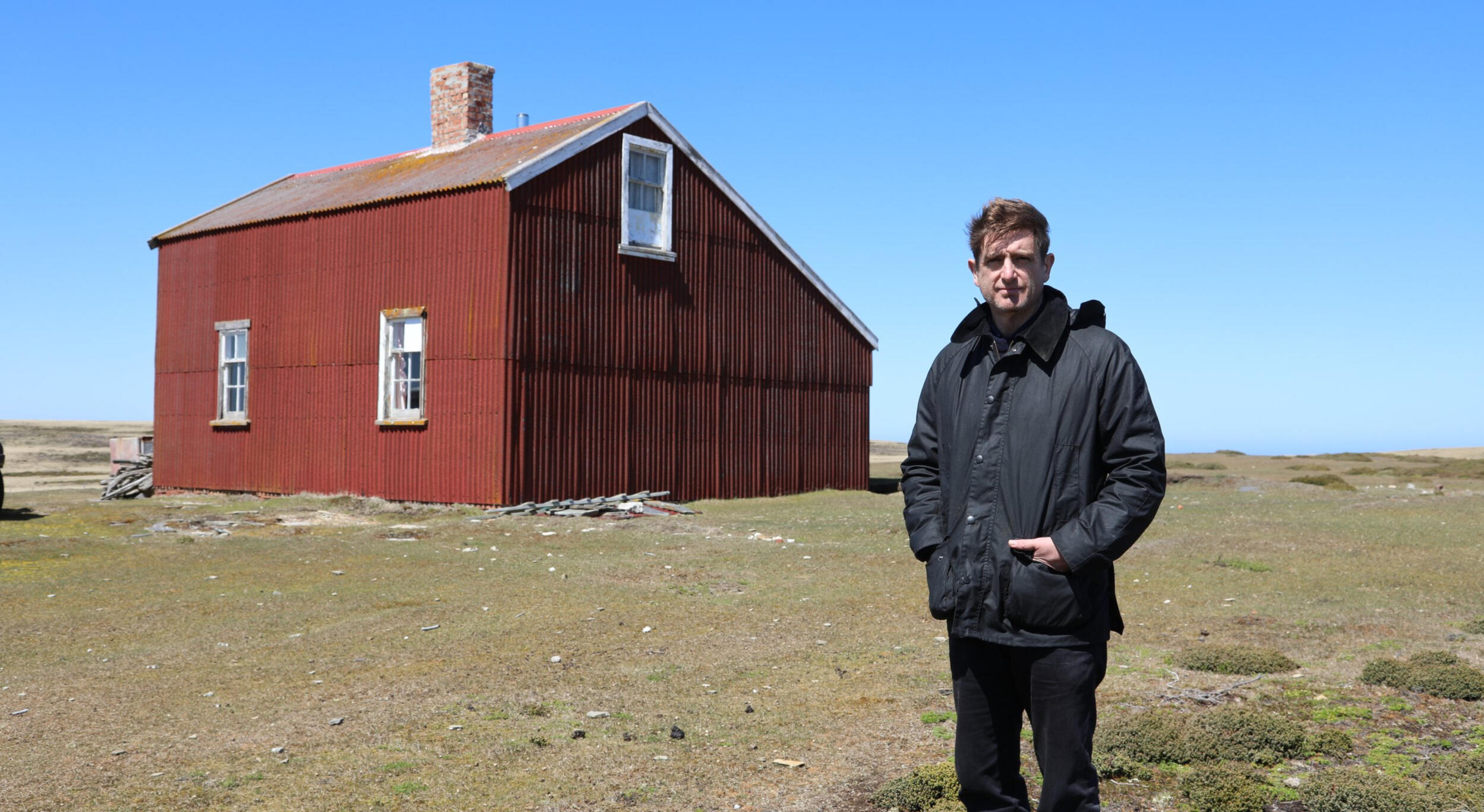 Marcel Theroux next to a red barn